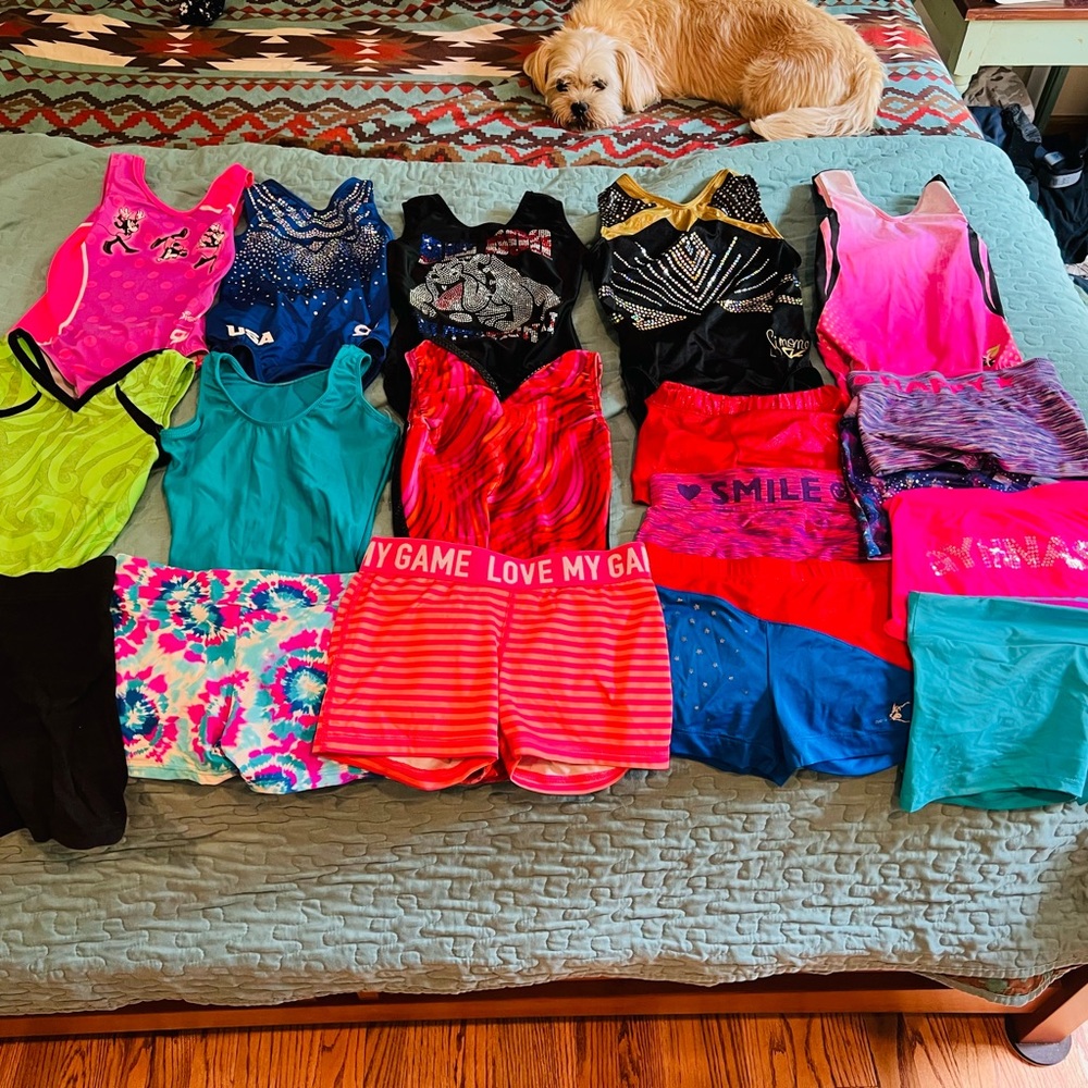 8 gently used leotards and 11 pairs of gymnastics shorts sizes child sm-lg